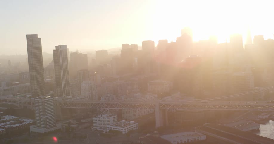 The sun shines over an urban skyline