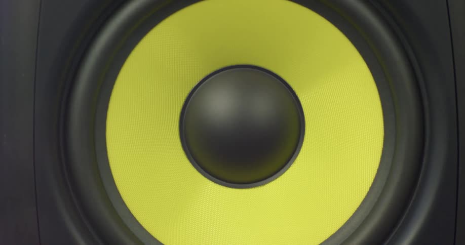 A yellow and black speaker vibrates and pulses with sound