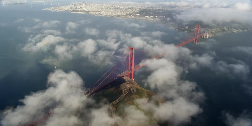 Aerial view of a bridge over the water crossing towards the city skyline