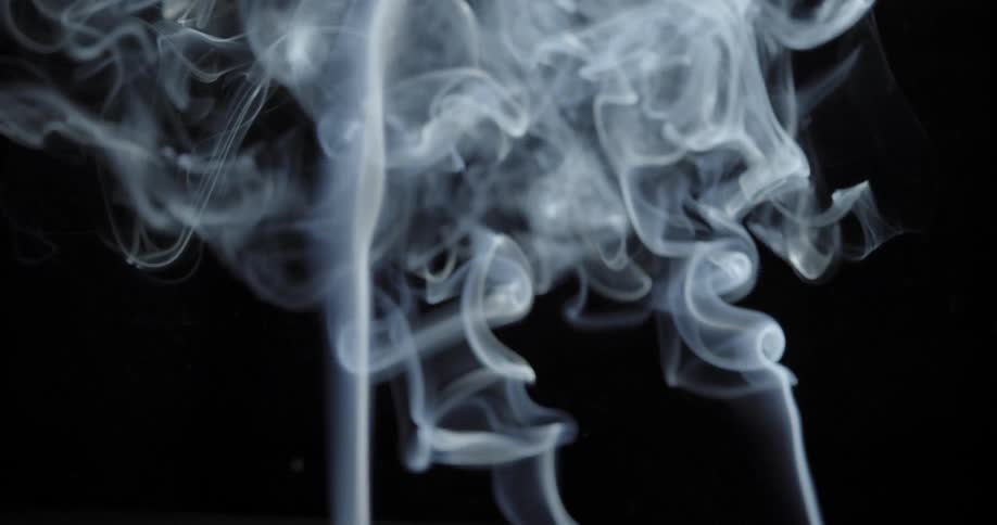 Plumes of cigarette smoke rise into the air