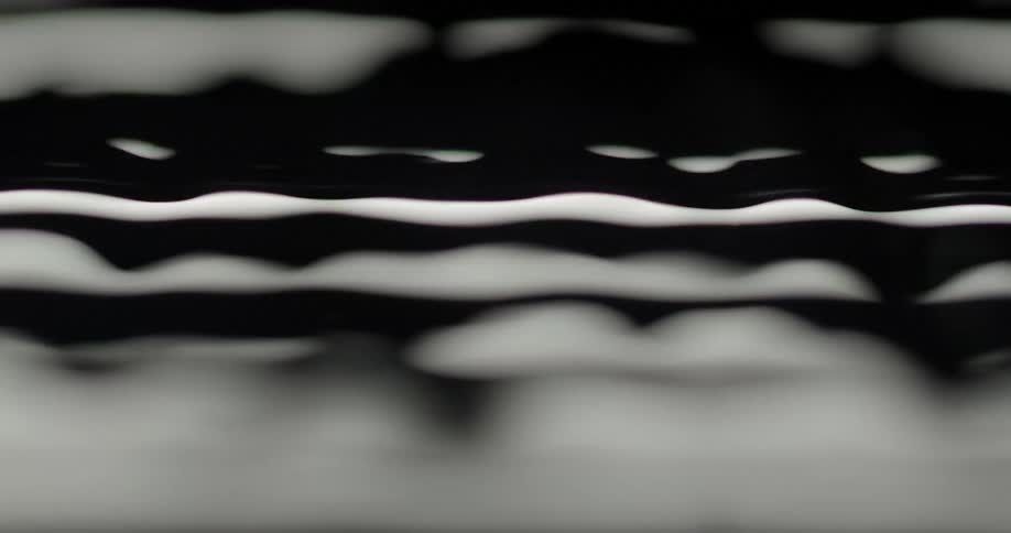 Moving water reflects bands of light