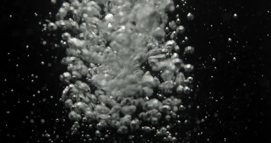 Bubble shooting down into a liquid before slowly rising again