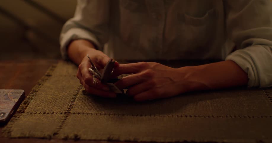 Man sitting on a table handles keys on a keyring