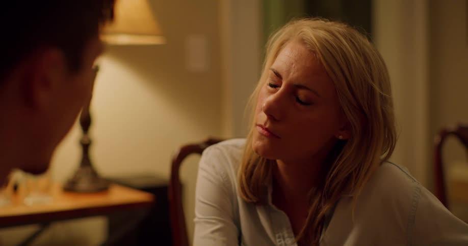 A white woman listens to a man talking and then dissolves into tears