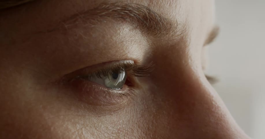 Hazel eyed woman stares into space