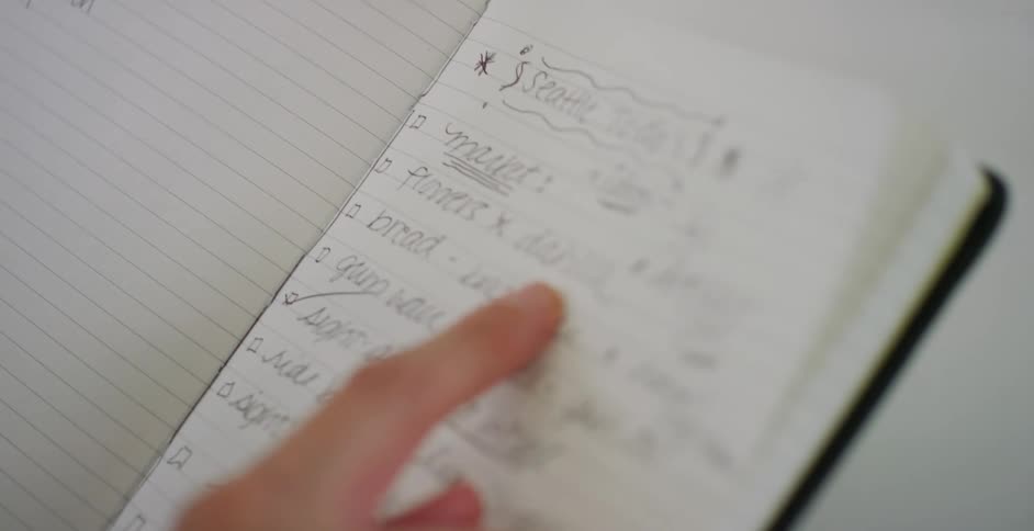 Person reviews checklist in notebook