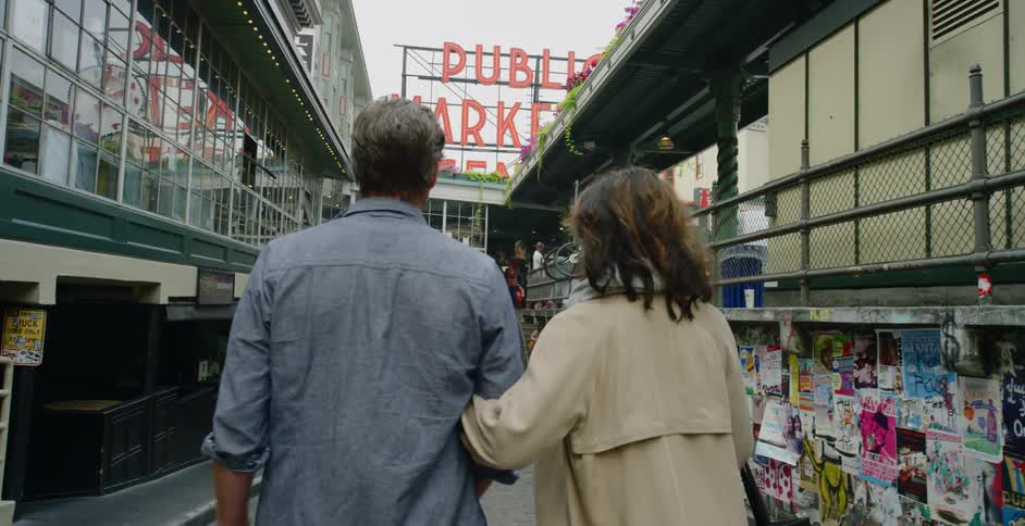 A couple walk together down the city street