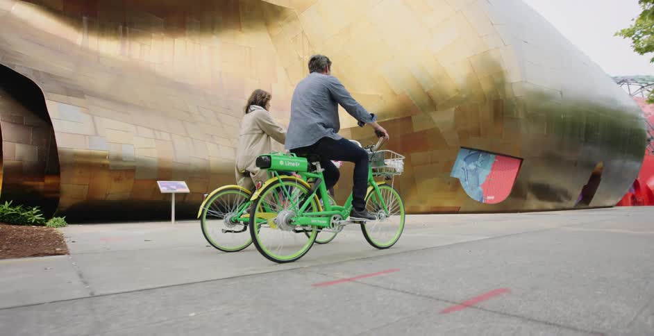 A man and woman riding bike