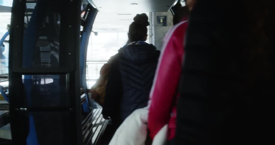 A group of teenagers get on to a gondola car