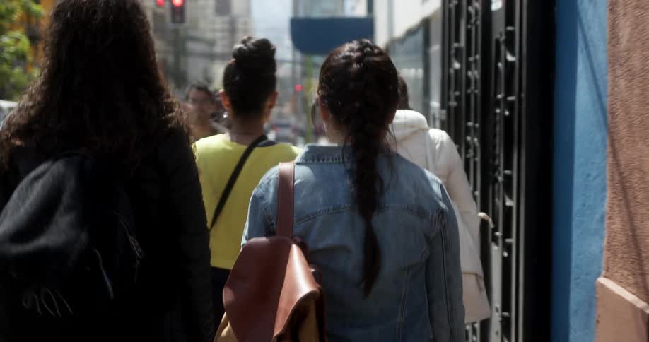 A group of teenage girls walking down a city street