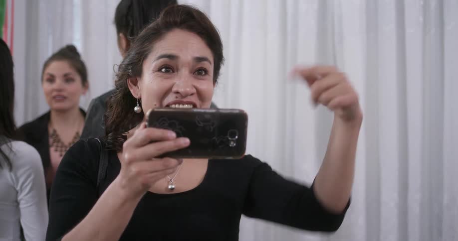 Woman taking a picture with her cell phone