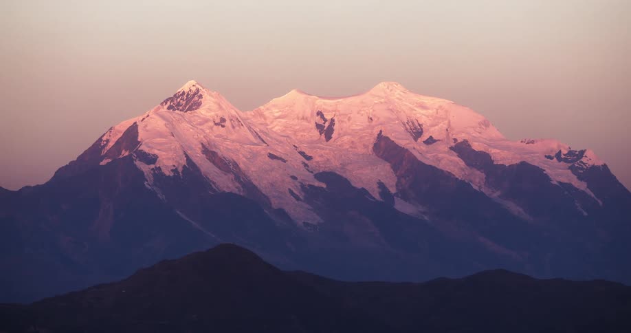 Sun tints snow on mountain top pink