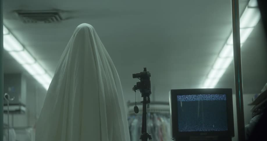 A ghost stands near the television