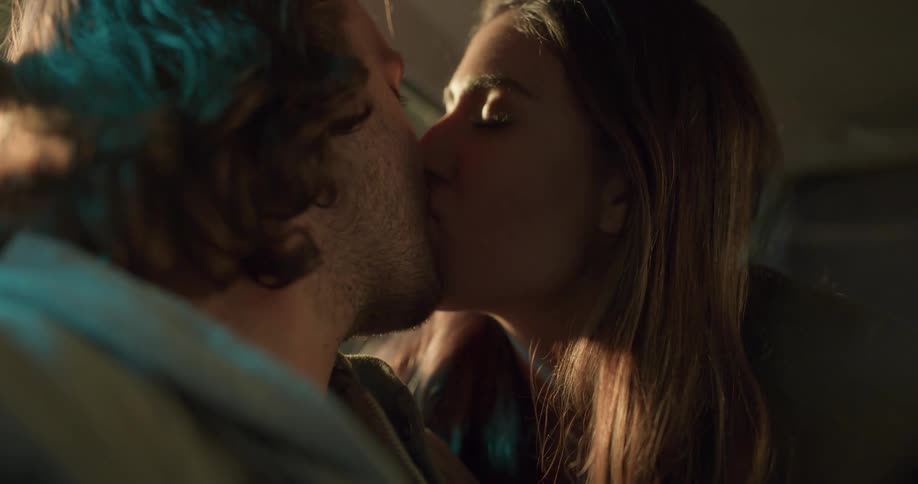 A couple kiss in the dark room