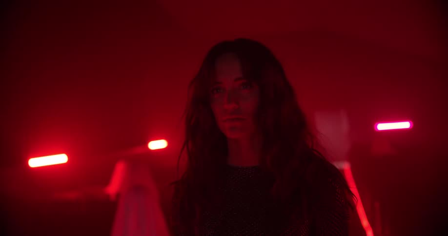 A woman walks through a misty room