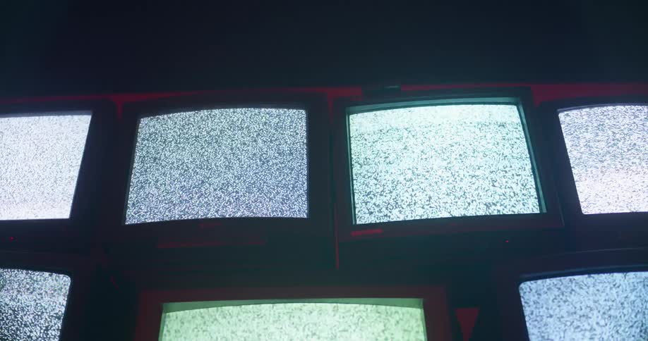 Wall of tube televisions with static on screen