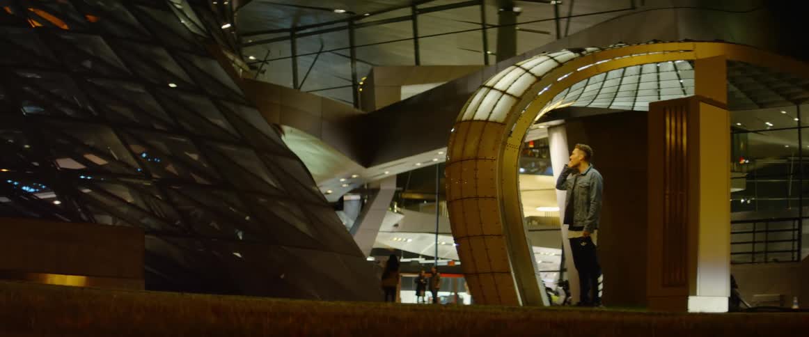 Small talks on his smartphone near an airport terminal