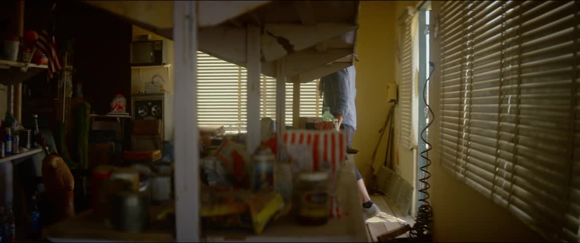 A man walks in to a home an looks around