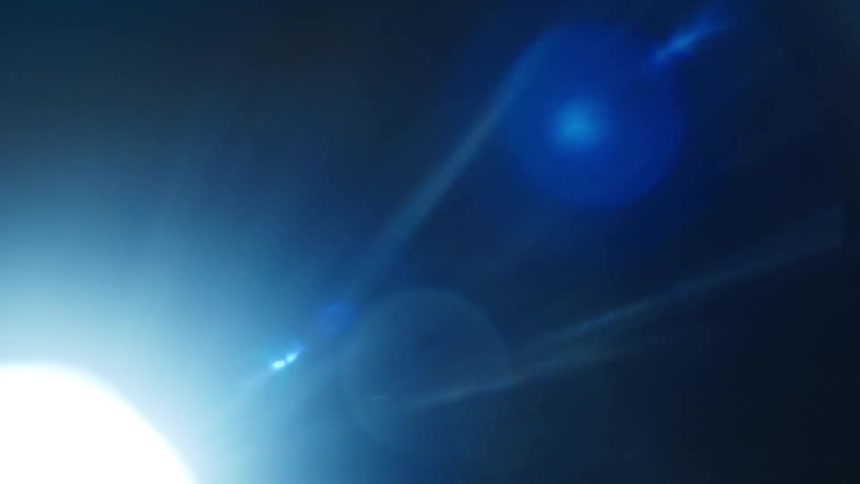 A light shines against a dark background