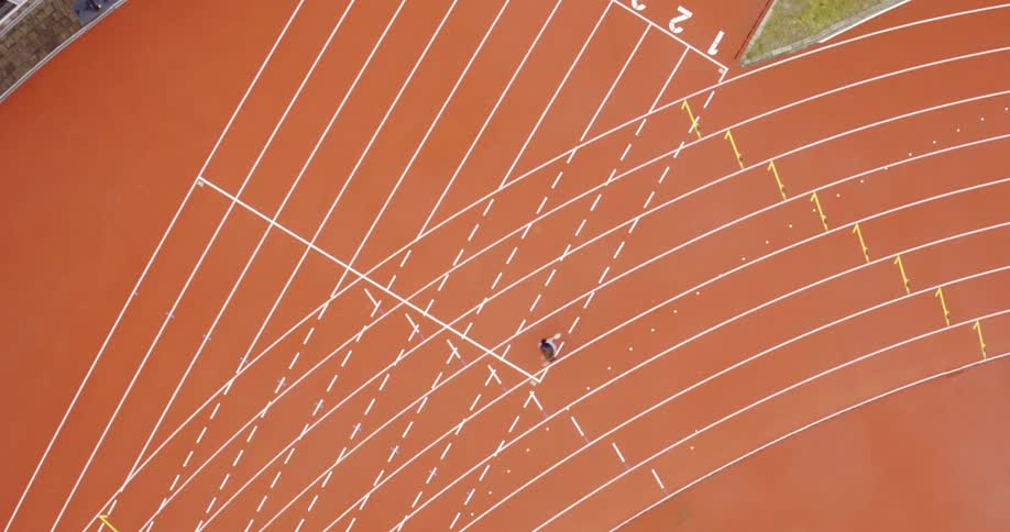 A person runs on a track and field track