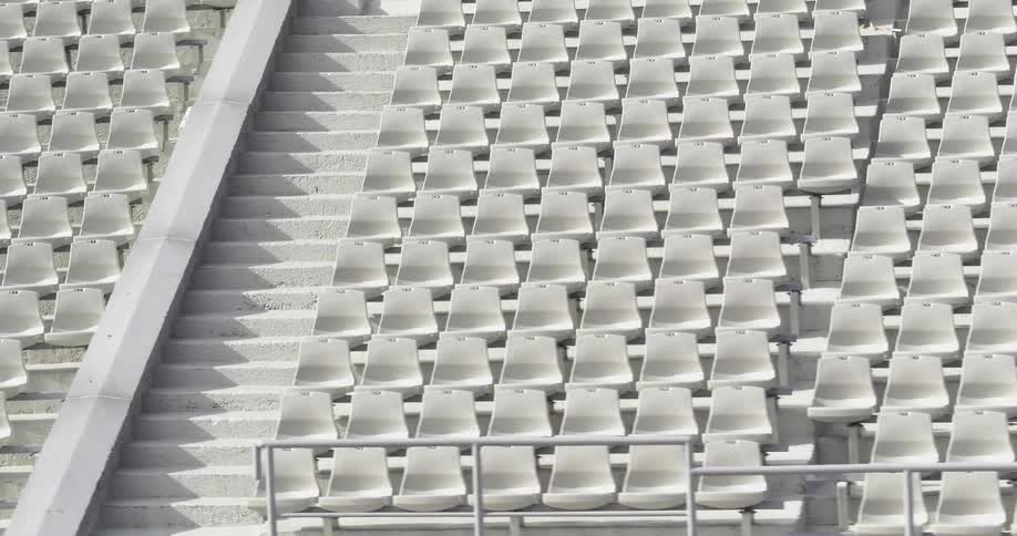 White seats match white of steps and floor in stadium