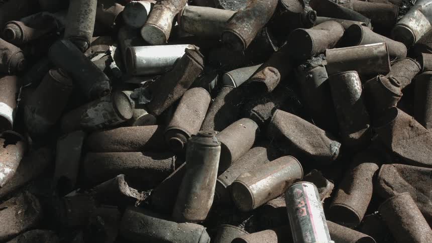 Pile of old rusted metal cans