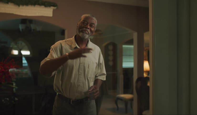 Senior citizen in his home smile and greets someone