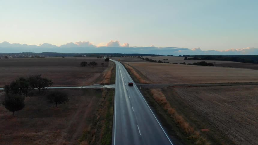 A vehicle travels a lone countryside road
