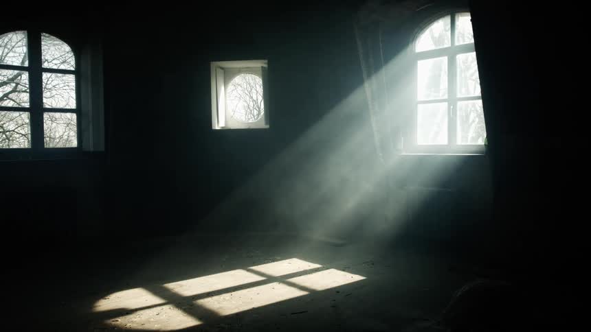 The sun shines through the windows into a dark room