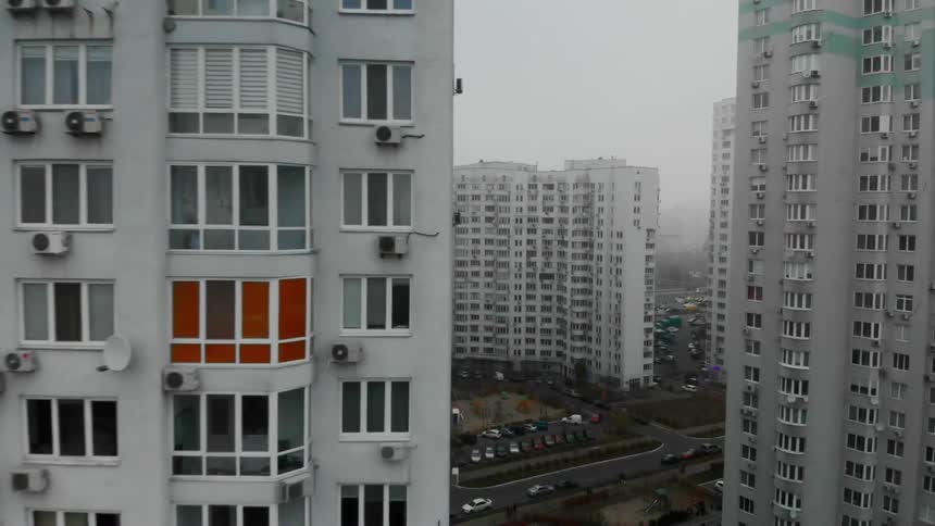 Smog fills a neighborhood with several tall and wide apartment buildings