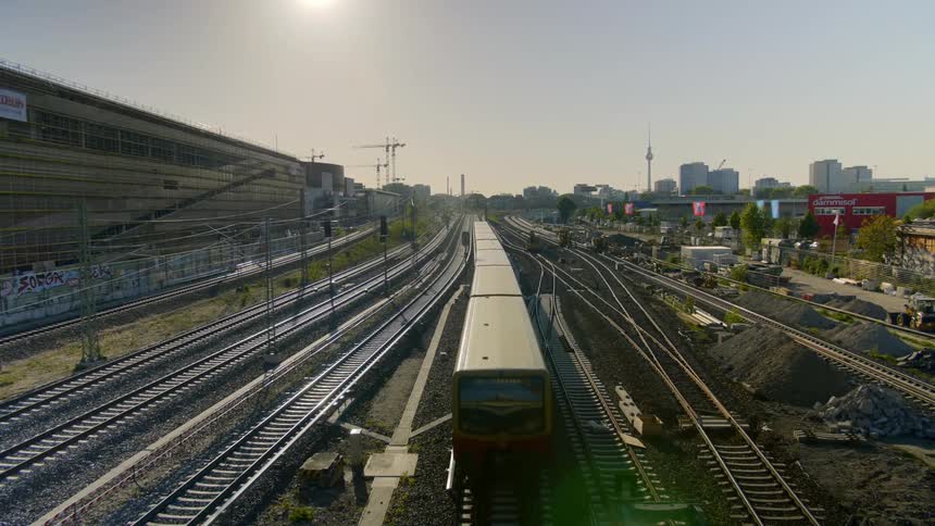Train travels on the tracks in the city