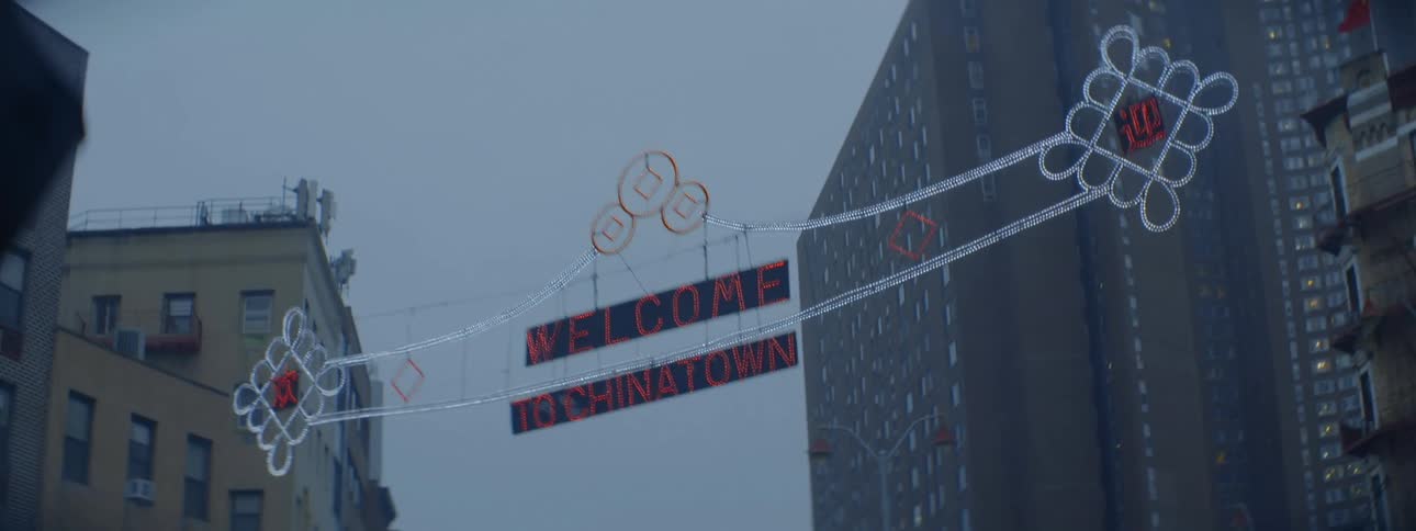 A large lit welcome sign is on the street in front of the city