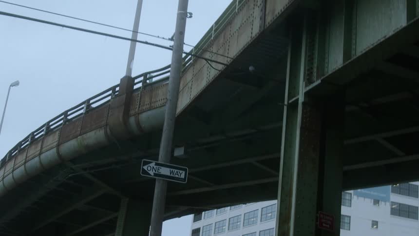 The overpass runs over the city street