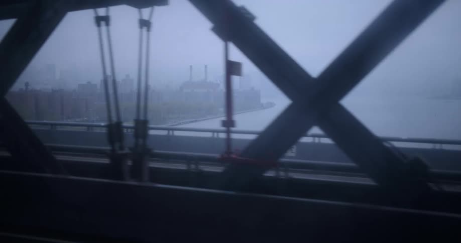 A heavy fog sits over a river and a coastal area with a downtown part of a city