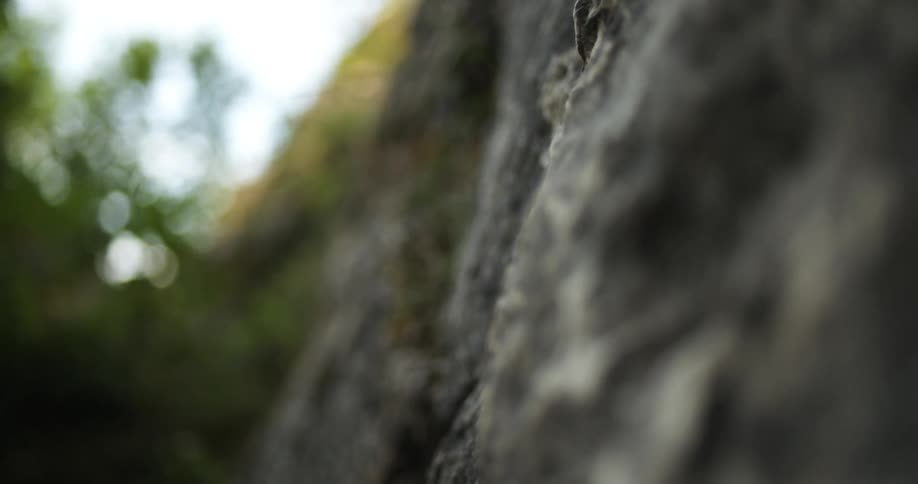 Rocks and stones roll down the side of a mountain