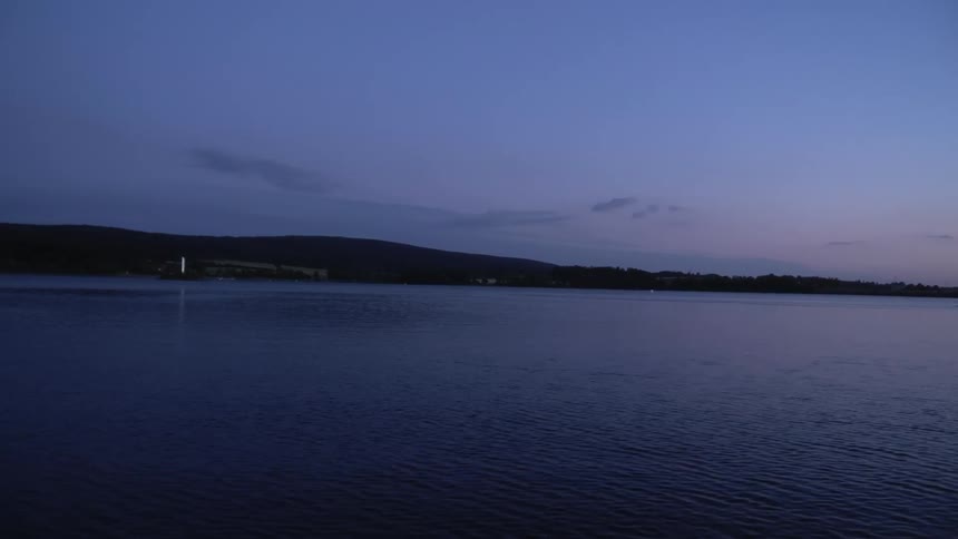 Sunset over the gentle slopes of a coastal town near the ocean