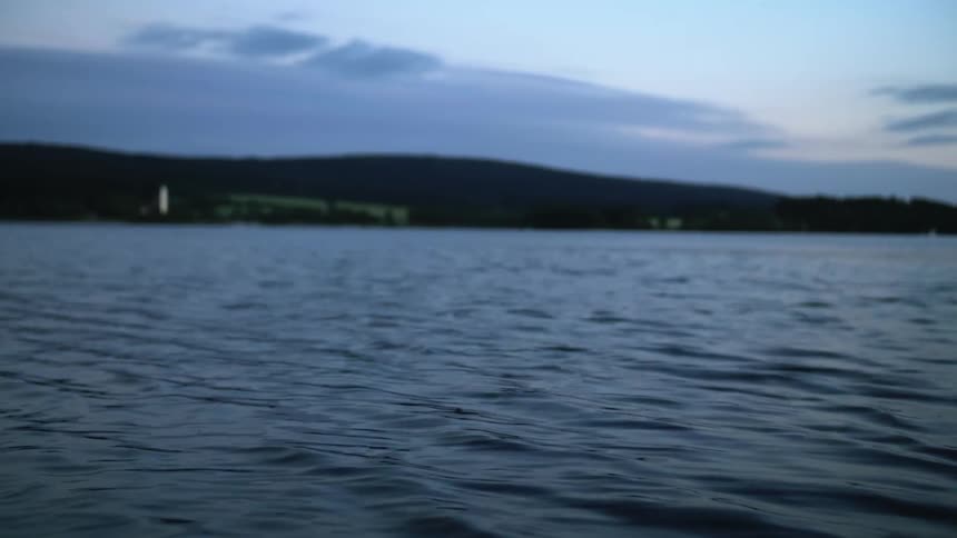Water ripples on surface of lake at dusk