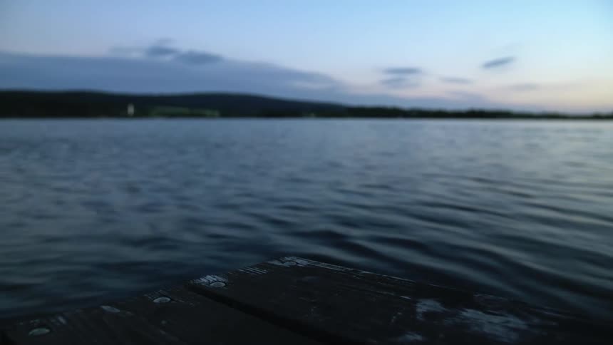Calm waters of a lake at sunset