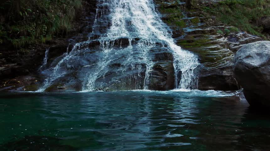 Water running down a waterfall in to the river below