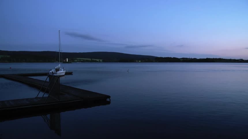 A boat at the dock on a lake