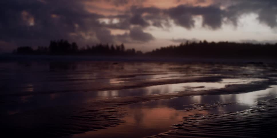 The sun is nearly set near the beach