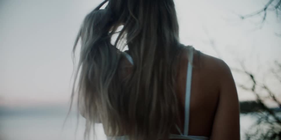 A woman walks by the beach