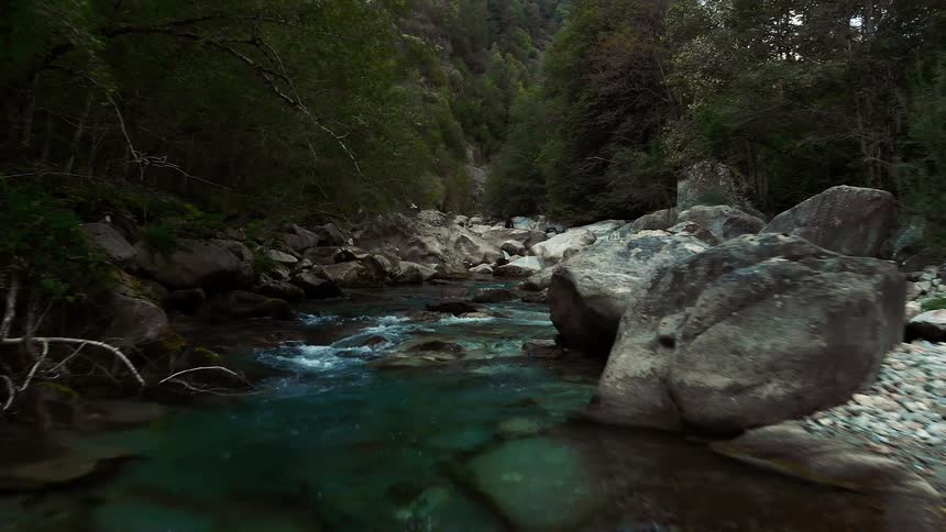 Hidden creek gently flowing down a stream bed in the canyon