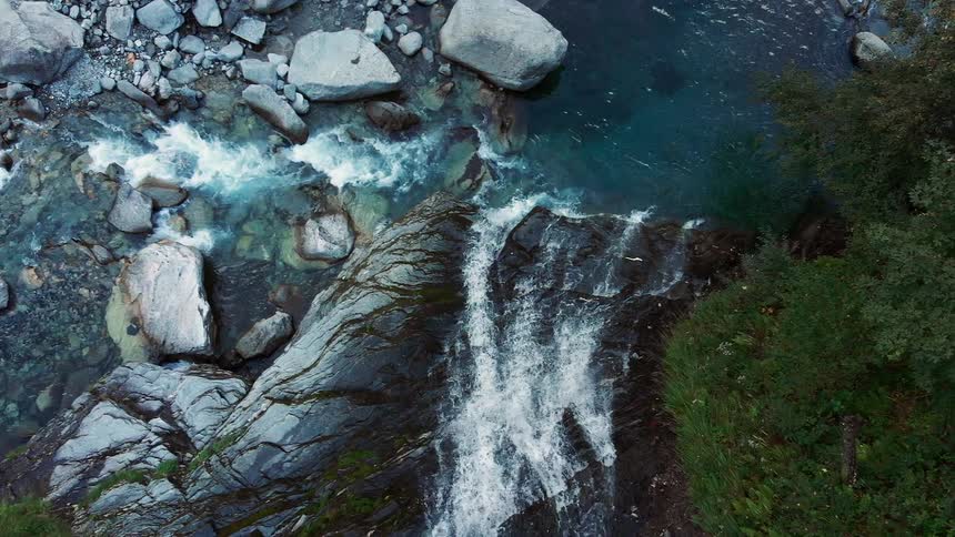 The water falls from two directions in the stream