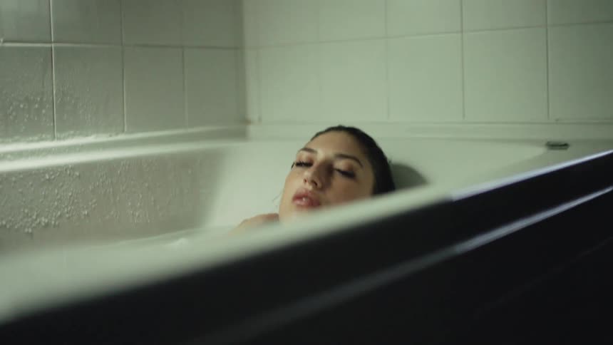 Woman takes a bath in a bathtub