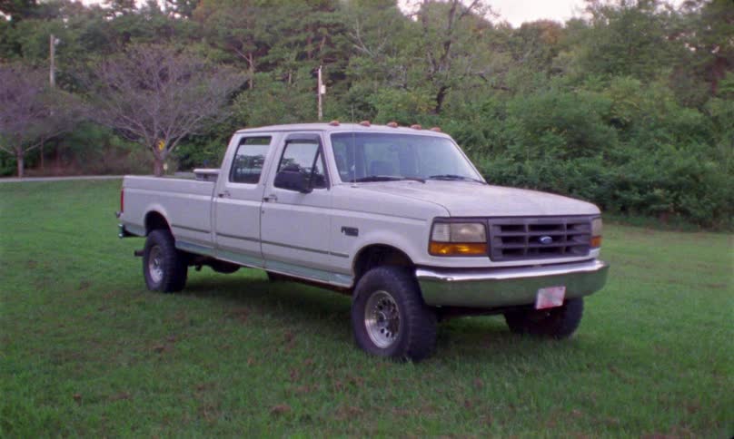 White dual cab ford truck parked in middle of the lawn