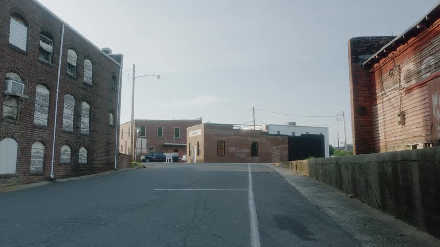 The street is quiet and empty between apartment buildings