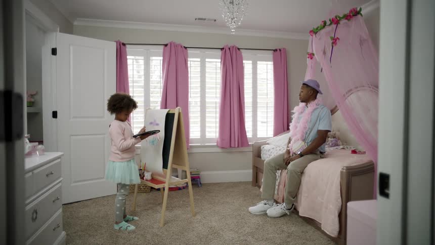 Father lets her daughter dress him up and make a crayon portrait of him