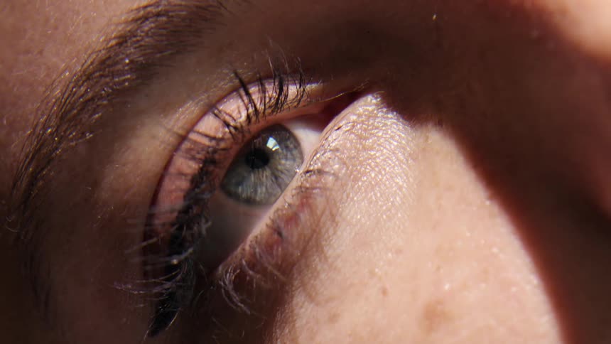 Woman opens her eye to the sun light.