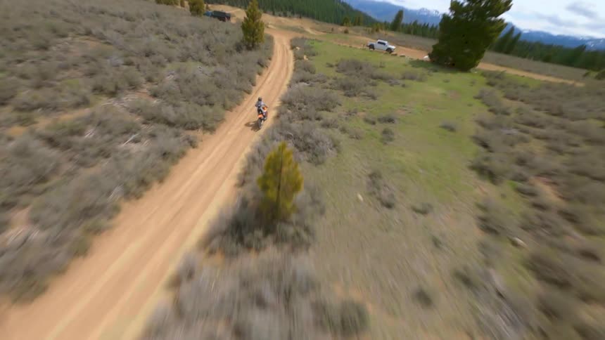 Aerial view of a motorcycle racing on a dirt road